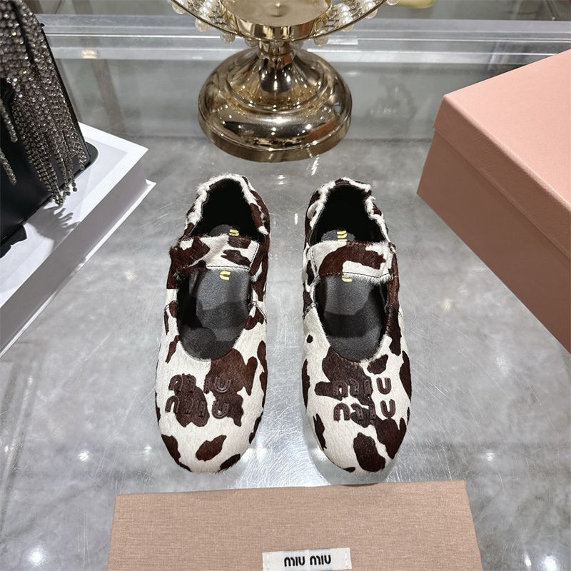Miu Miu ballet flats with a cow print design