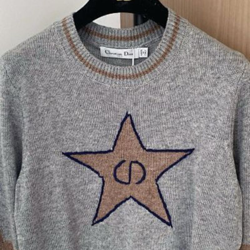 grey Christian Dior cropped sweater with a brown/tan star motif.