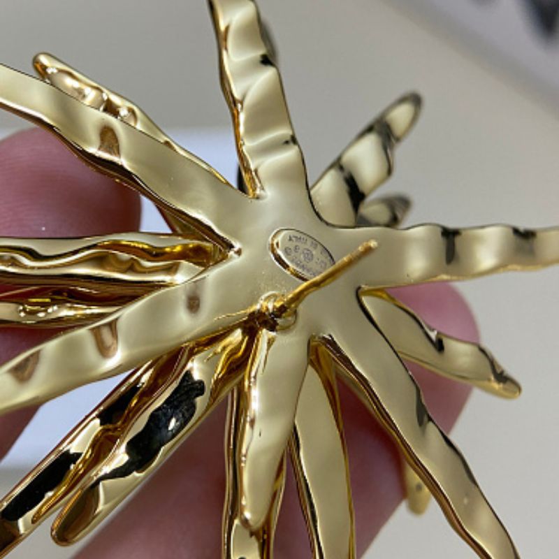 Chanel textured sunburst statement earrings