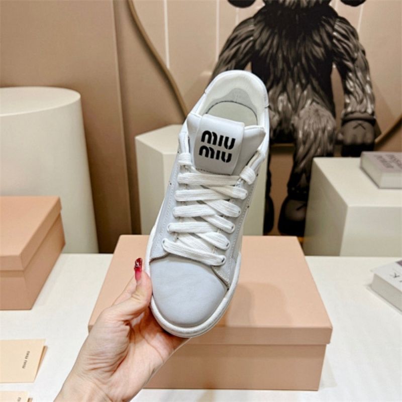 Miu Miu "Bleached Leather" sneakers in white.
