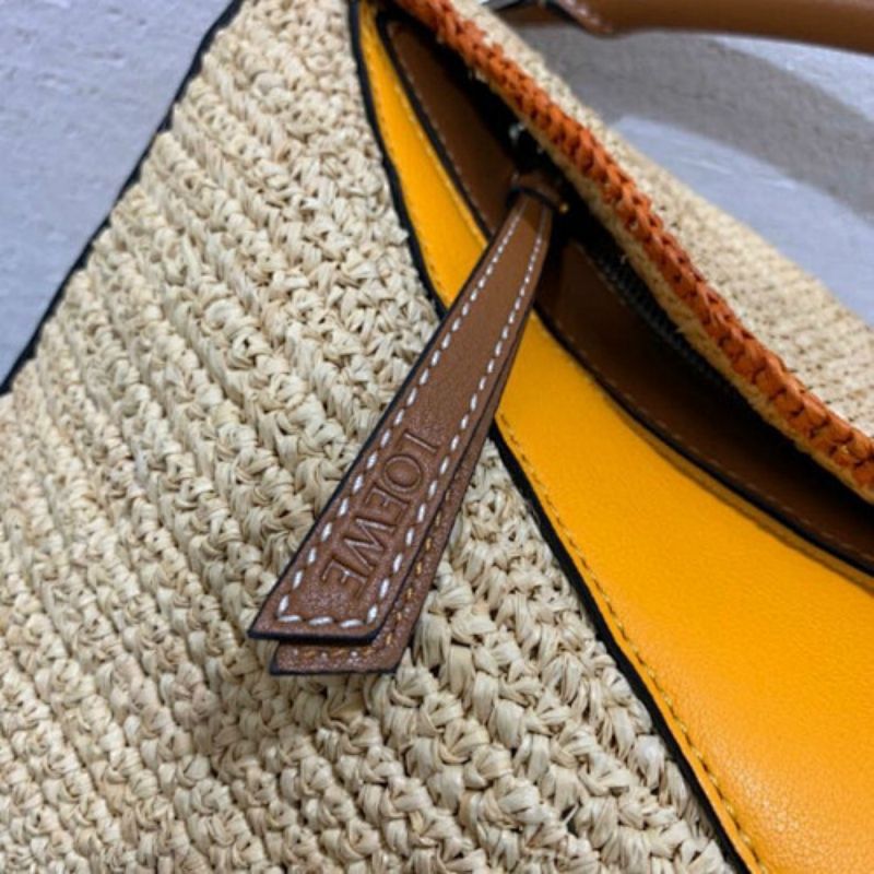 Loewe Puzzle Bag natural raffia with color-blocked leather panels.