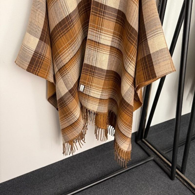 Gucci Reversible GG Wool Poncho in a camel and brown colorway.
