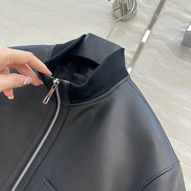 Hermès cropped, short-sleeve leather (or faux leather) jacket.