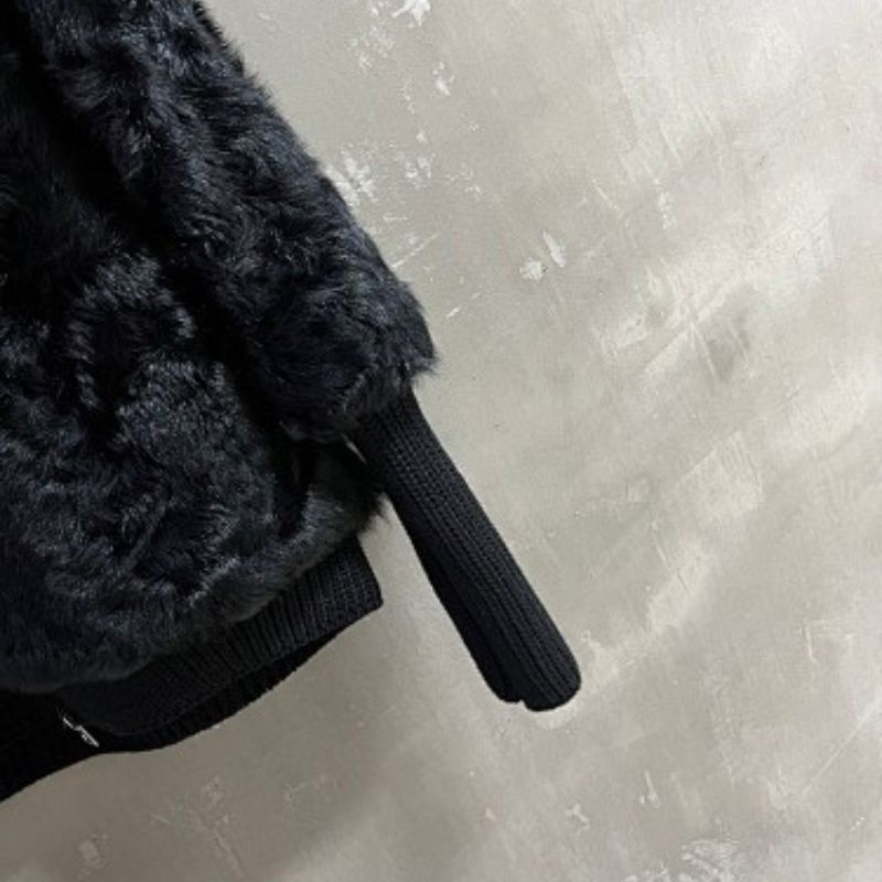 Christian Dior faux-fur jacket featuring contrasting black knit sleeves, collar, and hem