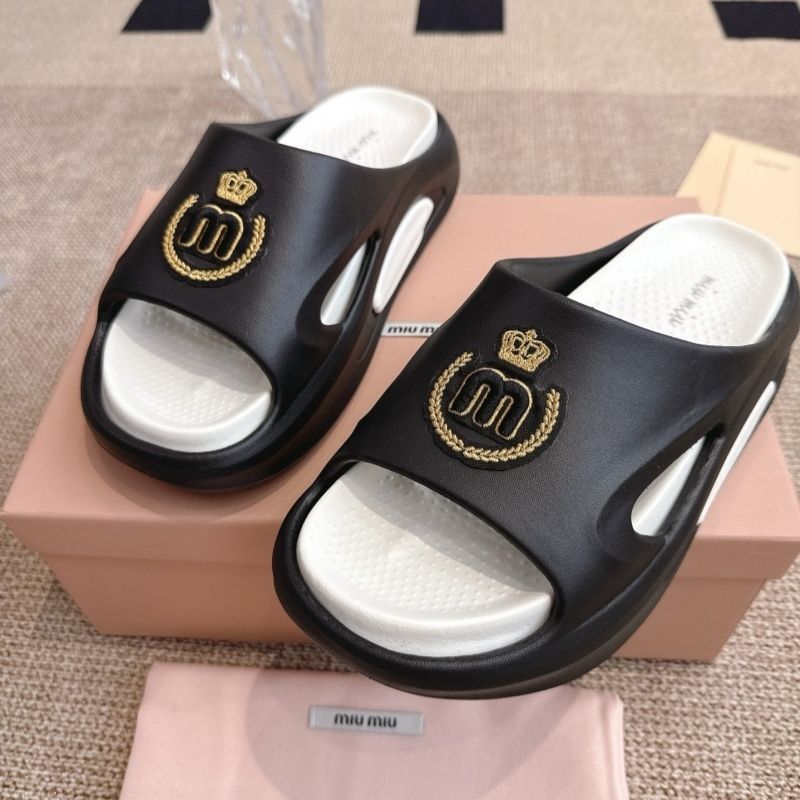 Miu Miu "Slides" sandals with a gold-tone emblem.