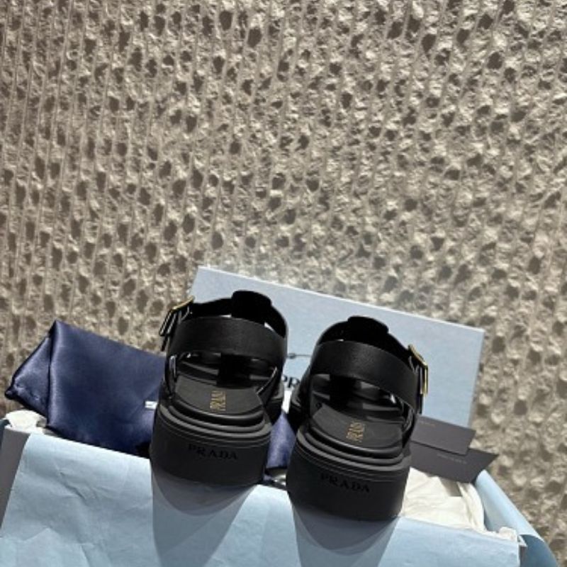 Prada Soft Leather Fisherman Cage Sandals in black.