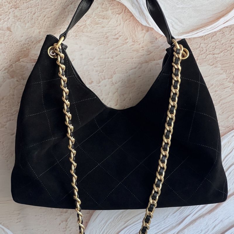 Chanel hobo bag with a gold chain strap and a prominent CC logo closure