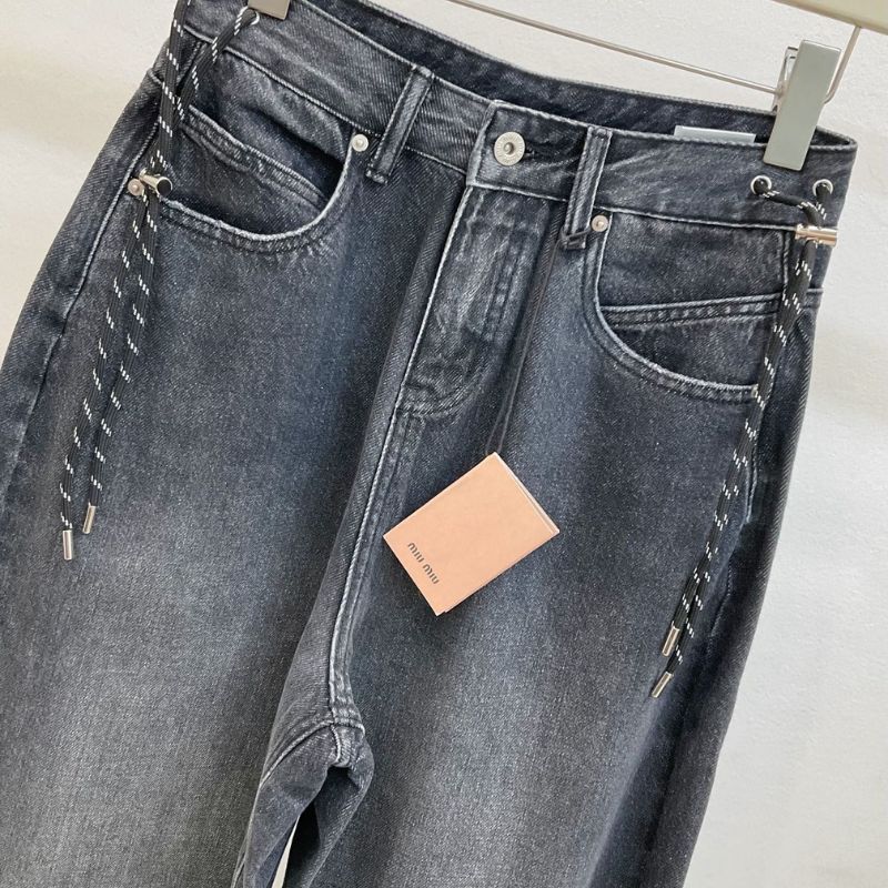Miu Miu dark wash, wide-leg denim jeans with a chain detail.