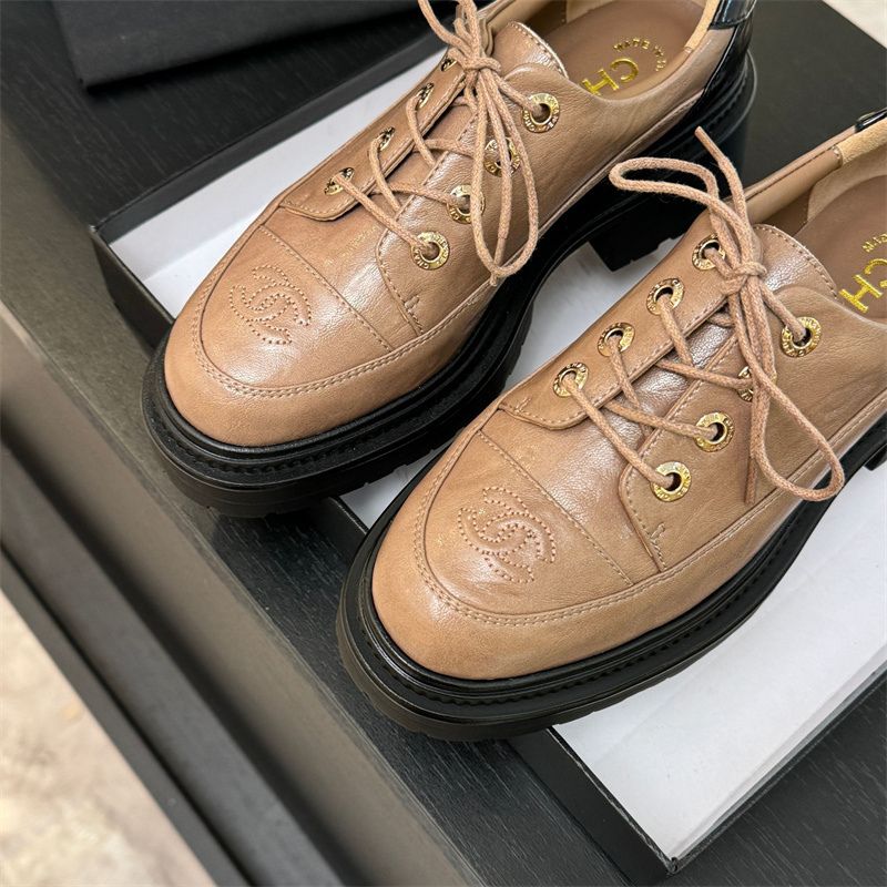 Chanel two-tone platform lace-up shoes.
