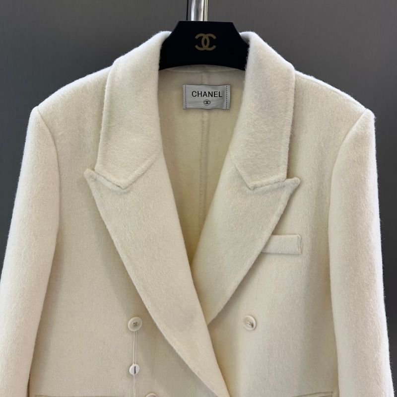 Chanel-style double-breasted blazer with feather cuffs.