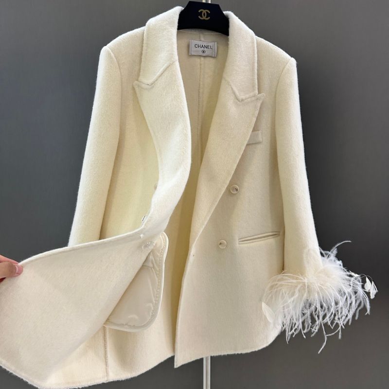 Chanel-style double-breasted blazer with feather cuffs.