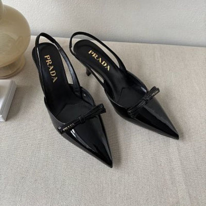 Prada Vernice Patent Leather Bow Slingback Pumps in black.