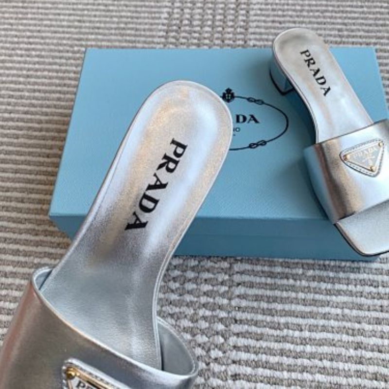 Prada Metallic Leather Flat Slide Sandals in silver.