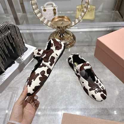 Miu Miu ballet flats with a cow print design
