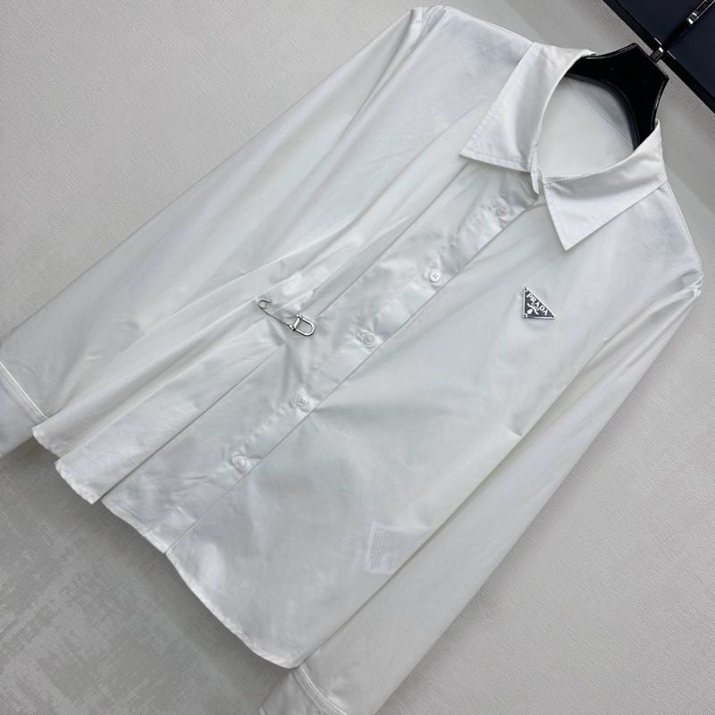 Prada poplin shirt with a pleated panel and safety pin detail.