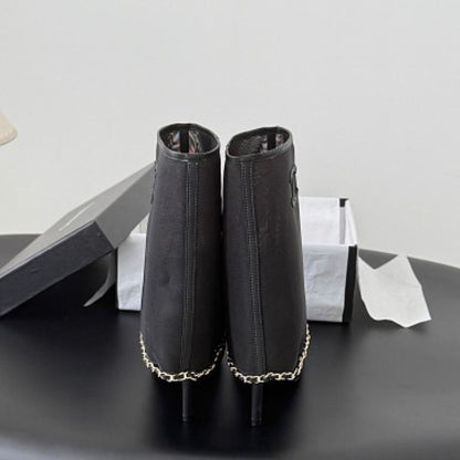 Chanel Mesh Peep-Toe Bootie Sandals in black.