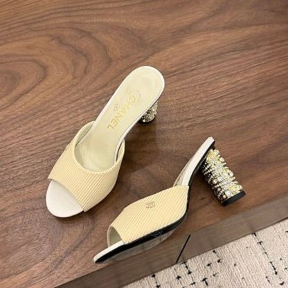 Chanel Ribbed Knit Open-Toe Mules in beige.
