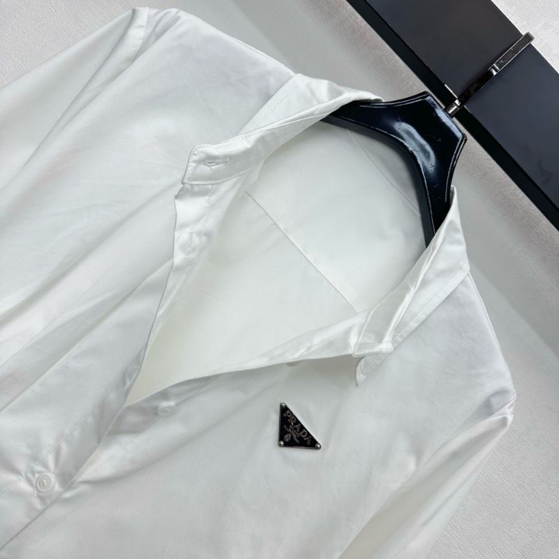 Prada poplin shirt with a pleated panel and safety pin detail.