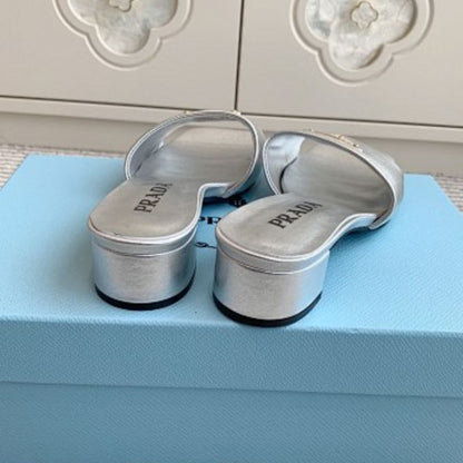 Prada Metallic Leather Flat Slide Sandals in silver.