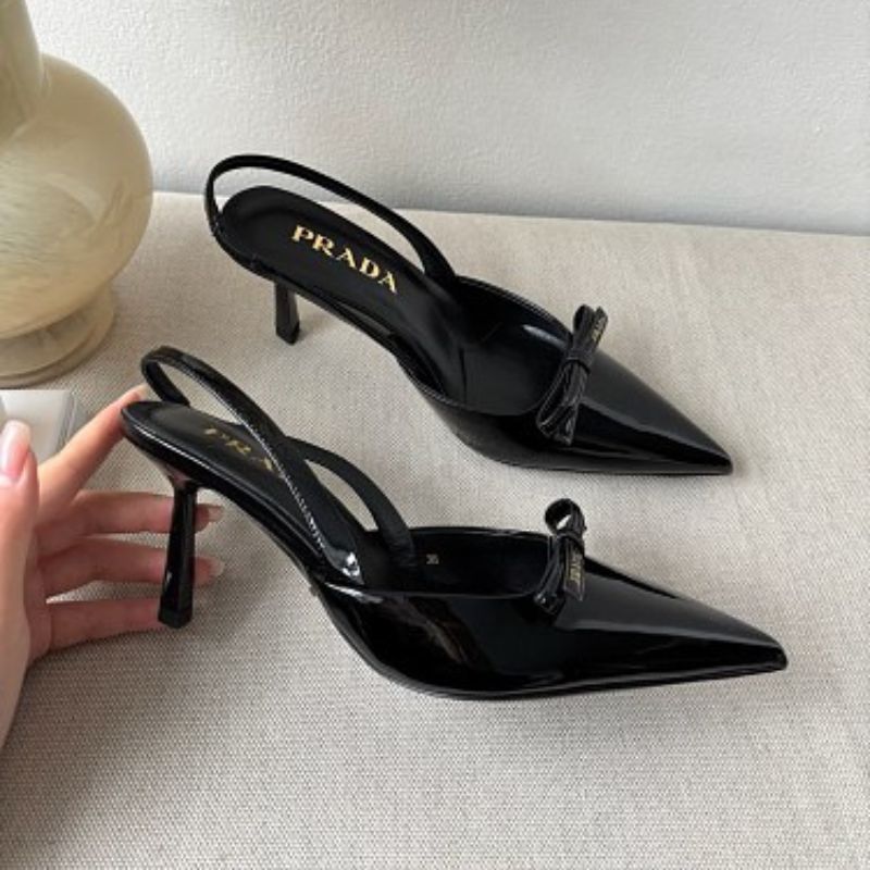 Prada Vernice Patent Leather Bow Slingback Pumps in black.