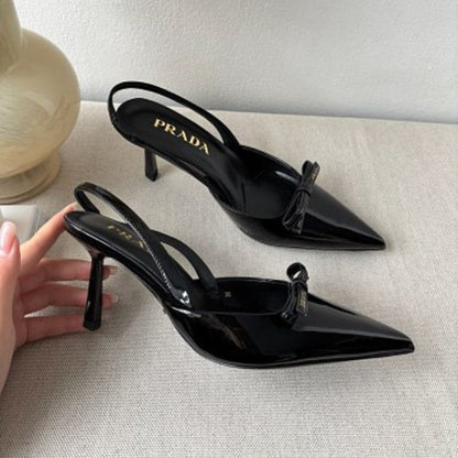 Prada Vernice Patent Leather Bow Slingback Pumps in black.