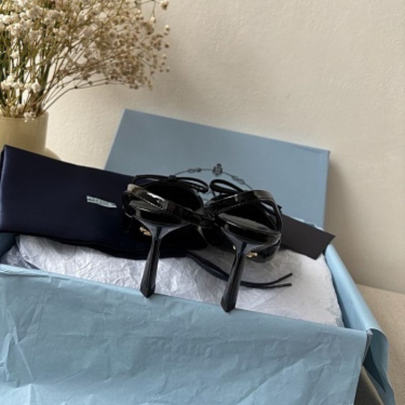 Prada Vernice Patent Leather Bow Slingback Pumps in black.
