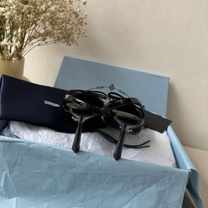 Prada Vernice Patent Leather Bow Slingback Pumps in black.