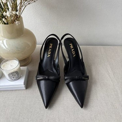 Prada Smooth Leather Bow Slingback Pumps in black.
