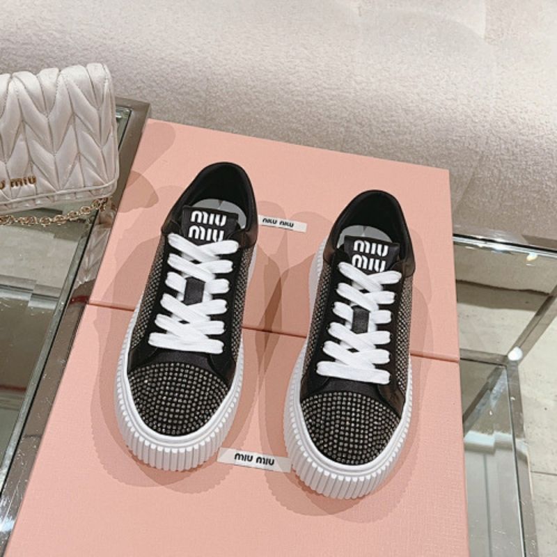 Miu Miu Mesh Flatform Sneakers in black.