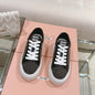 Miu Miu Mesh Flatform Sneakers in black.