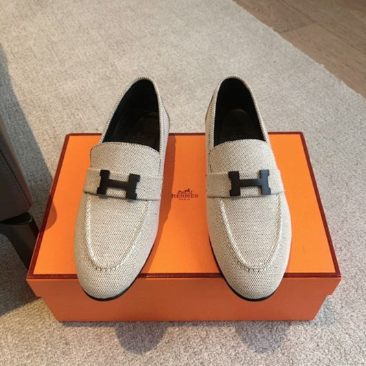 Hermès Paris Loafers in a textured, woven cream fabric finish.