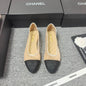 Chanel Ballet Flats in a two-tone beige and black colorway.