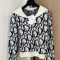 white and navy blue Christian Dior knit top with a white collar