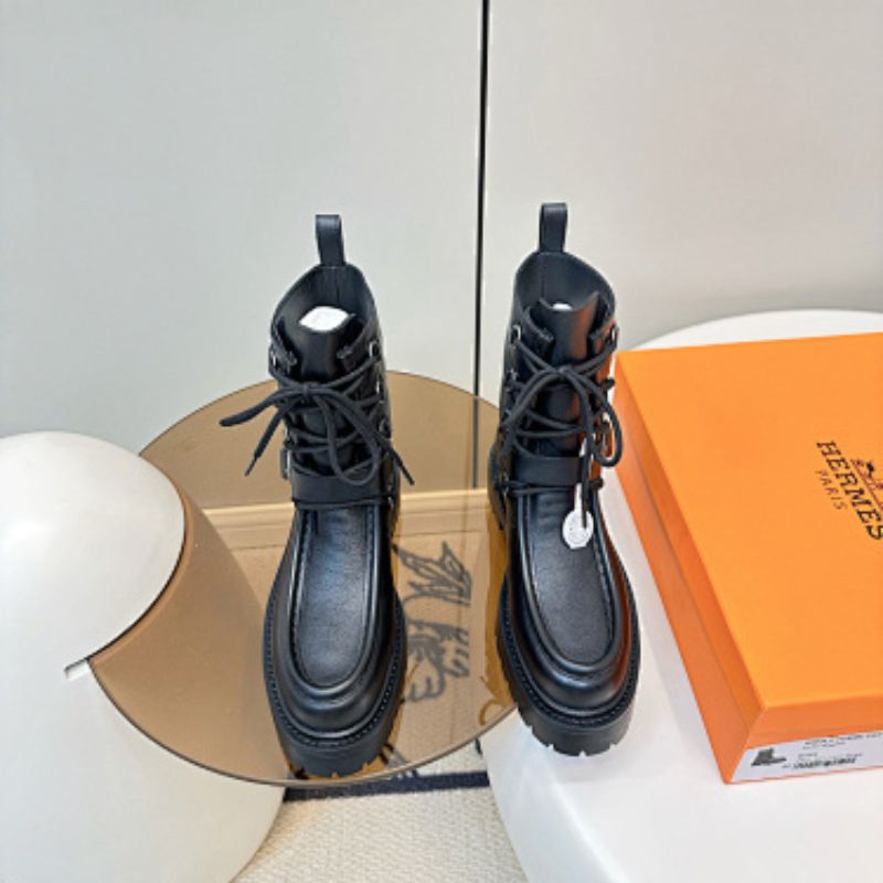 Hermès Land ankle boots in a classic black colorway.