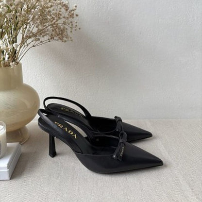 Prada Smooth Leather Bow Slingback Pumps in black.