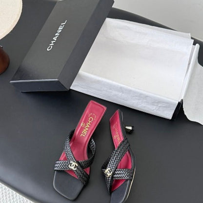 Chanel Braided Interlocking CC Mule Sandals in black.
