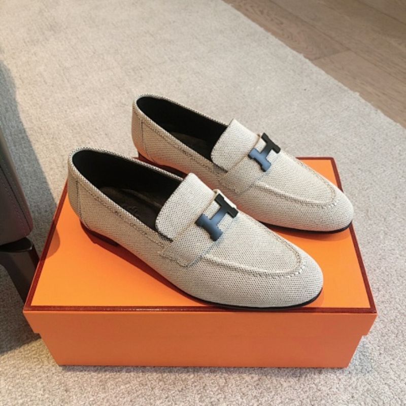 Hermès Paris Loafers in a textured, woven cream fabric finish.