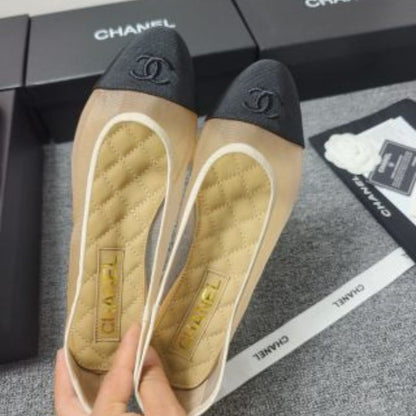 Chanel Ballet Flats in a two-tone beige and black colorway.