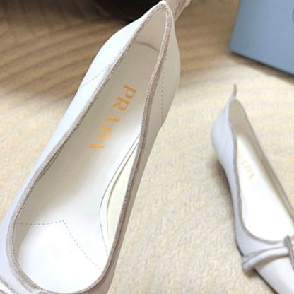 Prada Antiqued Leather Pointed-Toe Flats in the white and tan ("Bianco + Cuoio") colorway.
