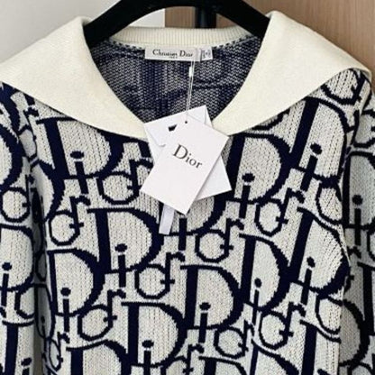 white and navy blue Christian Dior knit top with a white collar