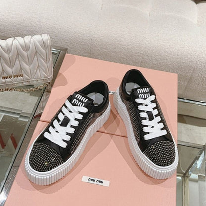 Miu Miu Mesh Flatform Sneakers in black.