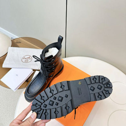 Hermès Land ankle boots in a classic black colorway.
