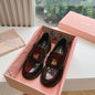 Miu Miu Brushed Leather Penny Loafers with a lug sole.