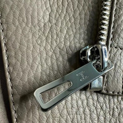 Hermes taupe asymmetrical zip jacket with wide, notched lapels, a cropped fit