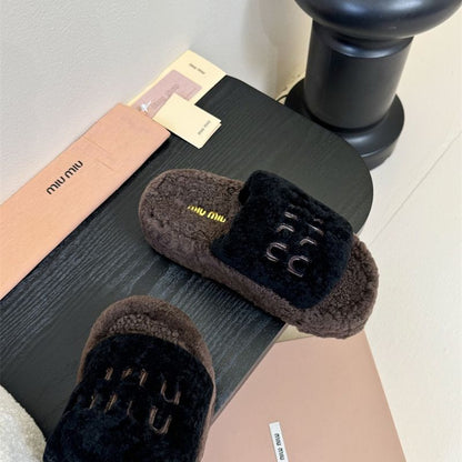 e Miu Miu Shearling logo-embellished Slippers.
