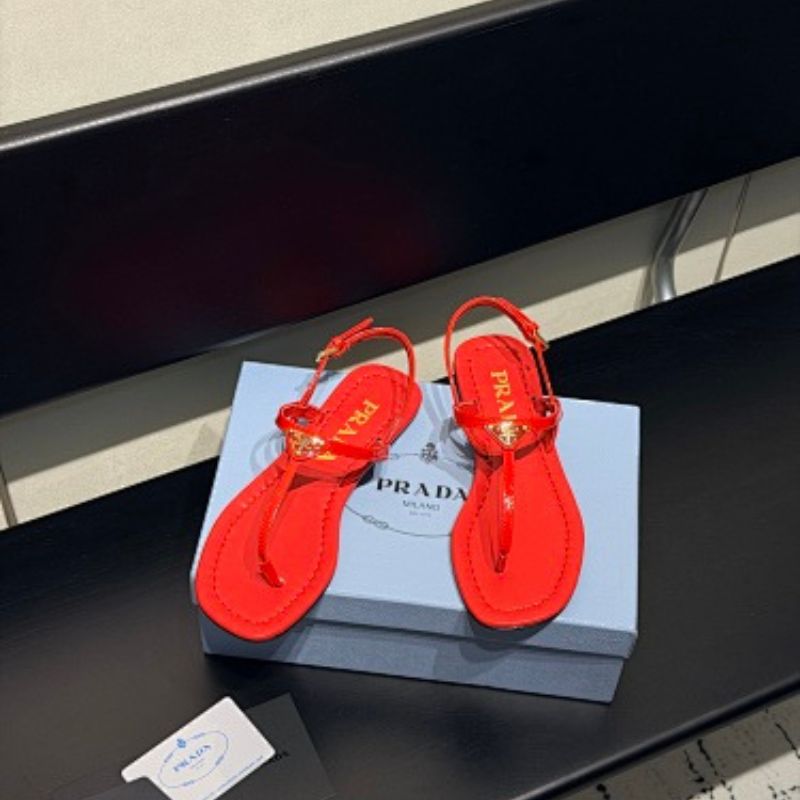 Prada Patent Leather Thong Sandals in a vibrant fiery red ("Fuoco") colorway.