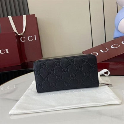 Gucci GG Emblem zip-around wallet in black embossed leather.