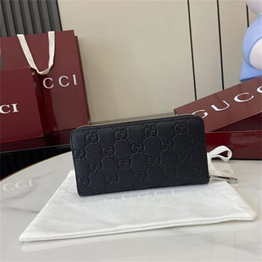 Gucci GG Emblem zip-around wallet in black embossed leather.