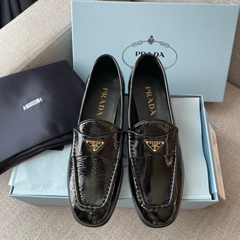 Prada Crinkled Patent Leather Loafers in classic black ("Nero").