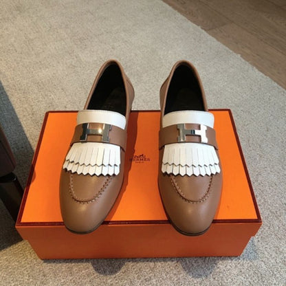 Hermès Royal Loafers in a bi-color tan and white leather combination.